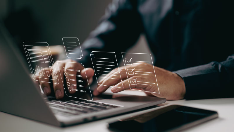 Person working with digital document controls displayed above a laptop